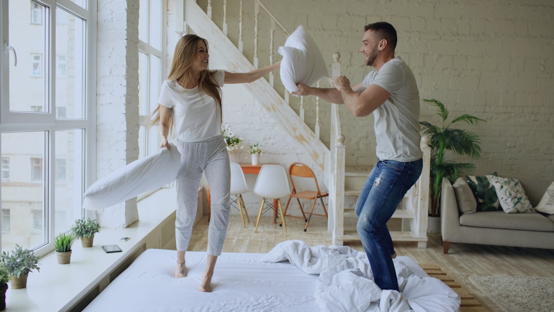 Couple having a pillow fight on a bed