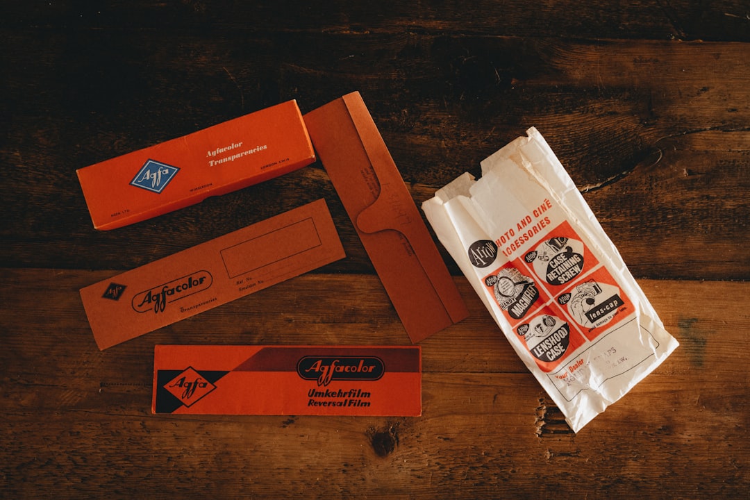 white and orange plastic pack on brown wooden table