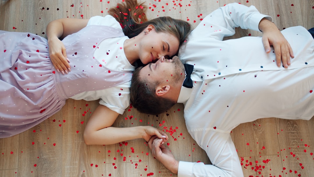 Couple lying on floor with rose petals