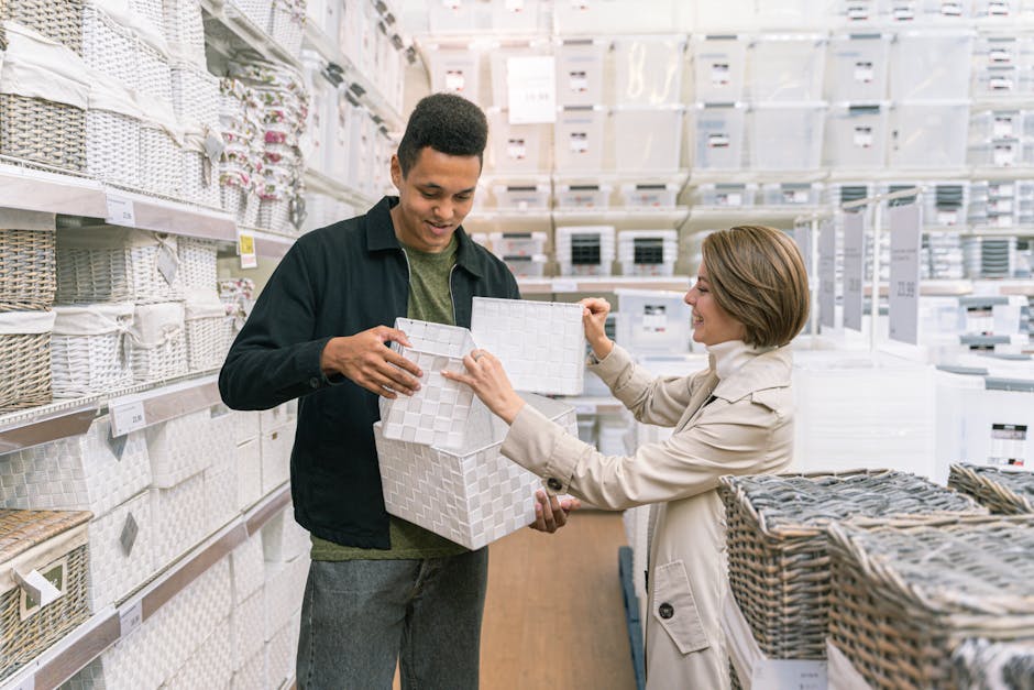Two adults shopping for storage baskets in a department store aisle.