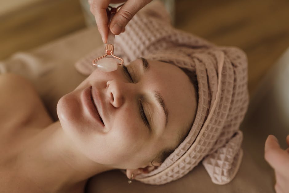 A serene moment during a beauty treatment with a jade roller massage for facial rejuvenation.