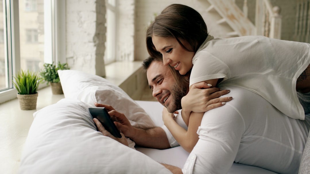 Couple looking at a tablet in bed