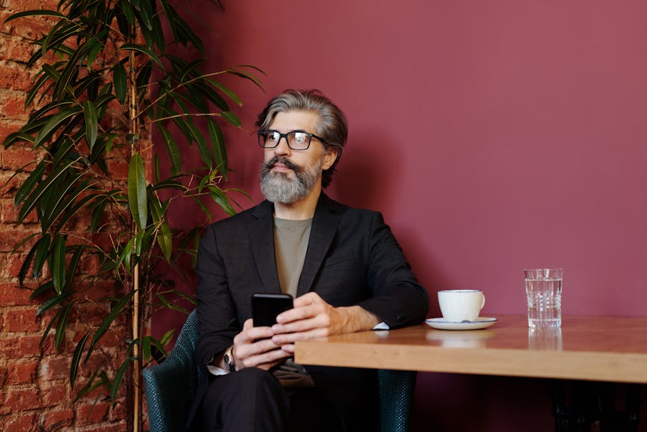 Mature man in a café enjoying coffee, displaying a sophisticated style and ambiance.