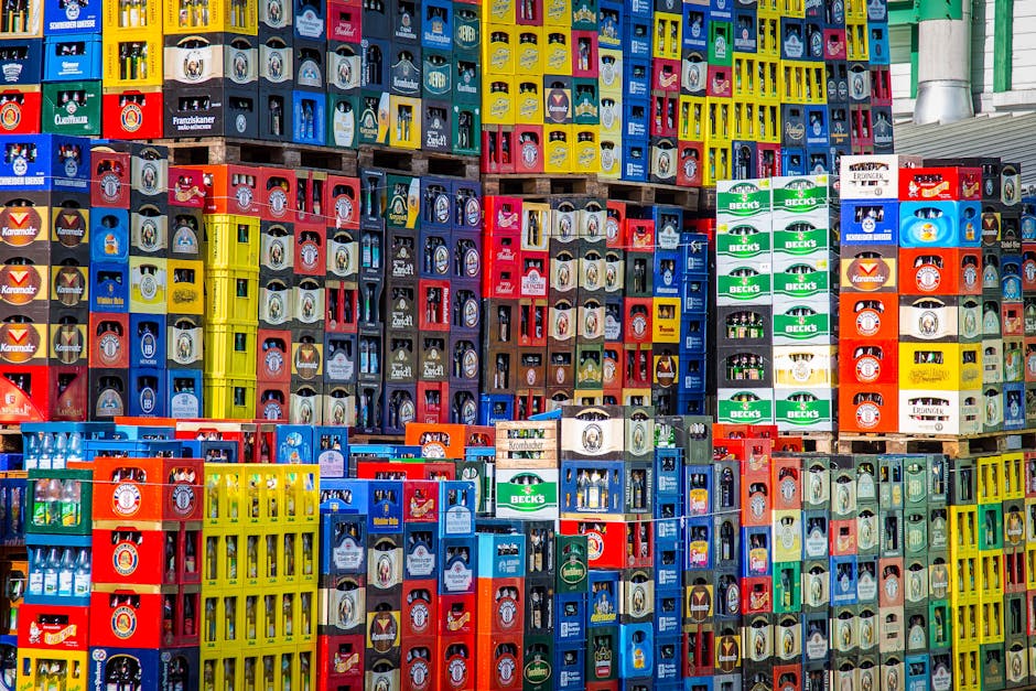 A vibrant display of beer crates stacked in a warehouse, showcasing various brands.