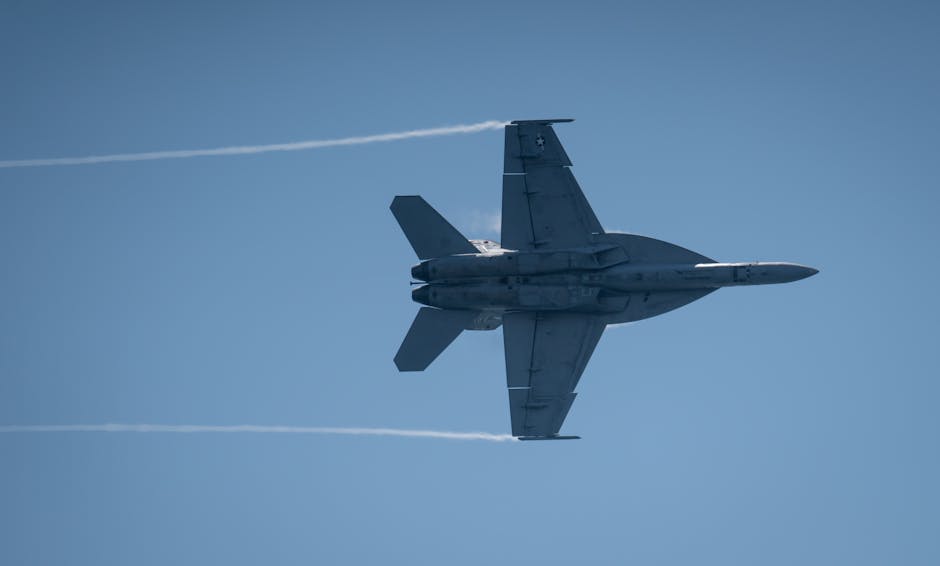F/A-18 Super Hornet jet flying at high speed during an airshow with clear skies.