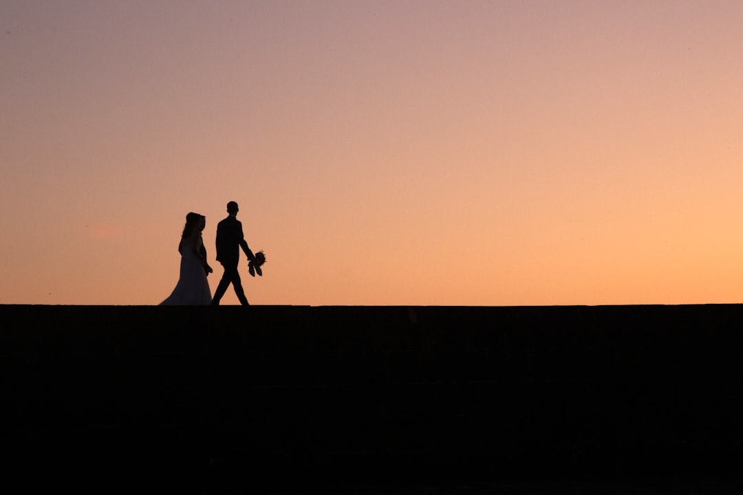 silhouette of two people during golden hour