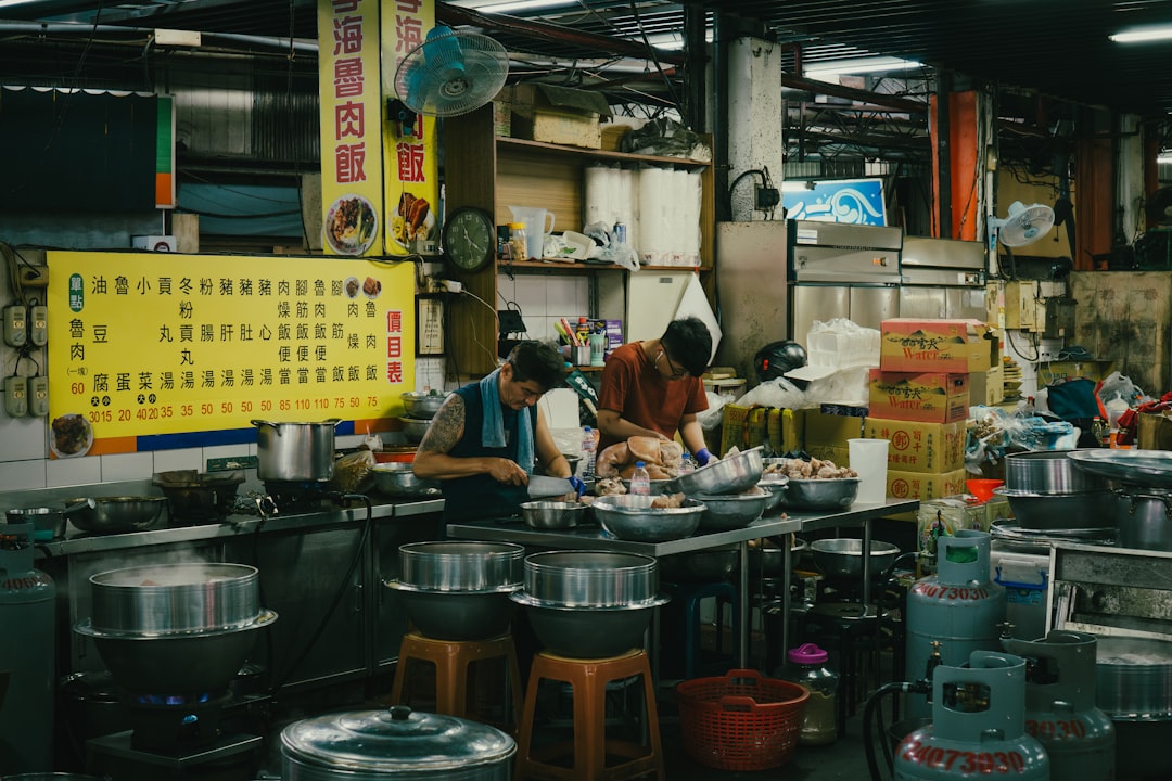 Chefs busy preparing food in a bustling kitchen.