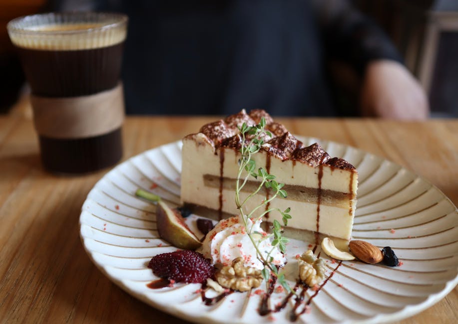 Close-up of tiramisu with nuts and coffee on a wooden table, creating a delicious culinary setting.